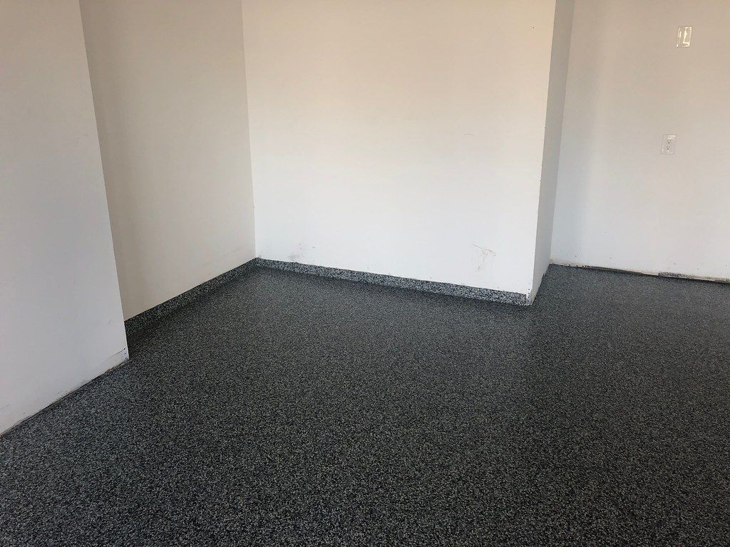 Decorative flake epoxy flooring system with grey and white chips for Cedar Rapids garages